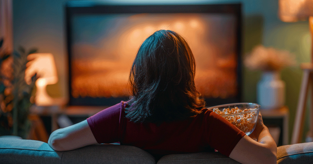 81-woman-relaxing-on-sofa-with-popcorn-watching-tv-630.png 